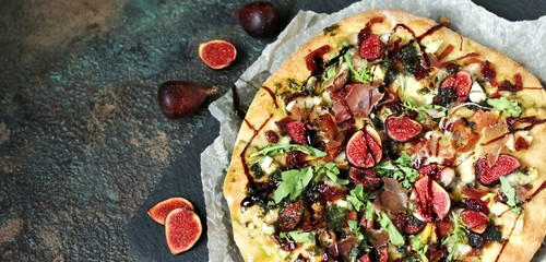 pizza with figs and prosciutto. different cheeses and gorgonzola, basil dressing with olive oil,...