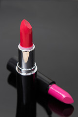 red lipstick or lipstick on black background