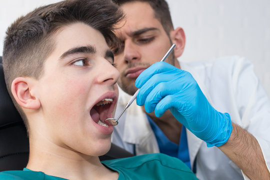 dentist checking the patient's mouth at the office
