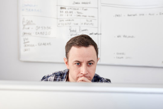 Businessman working on desktop computer in office