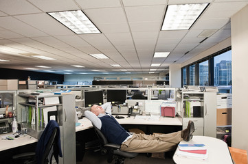 Businessman relaxing on chair in office