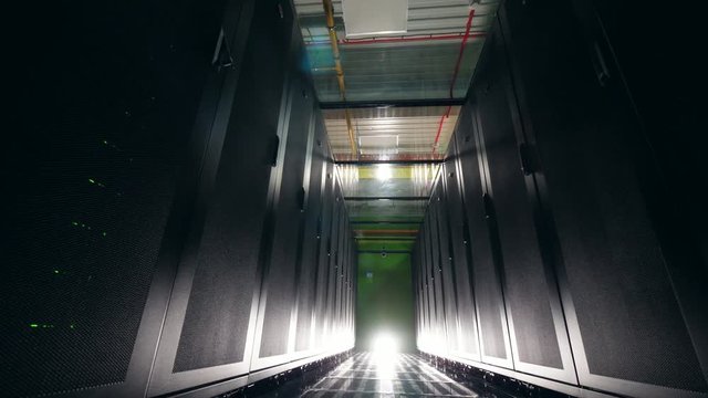 Empty corridor of the dark server room. Data center, security, data ptotection, data magement, data storage, server room, server rack, server farm, server computer