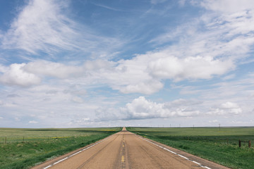 View of empty road passing through prairie