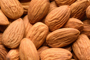 Peeled almonds closeup background. Top view