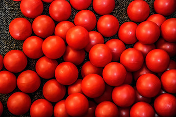 pile of red balls on the floor of a playground