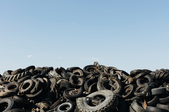 Pile of discarded auto and tractor tires in rural landfill