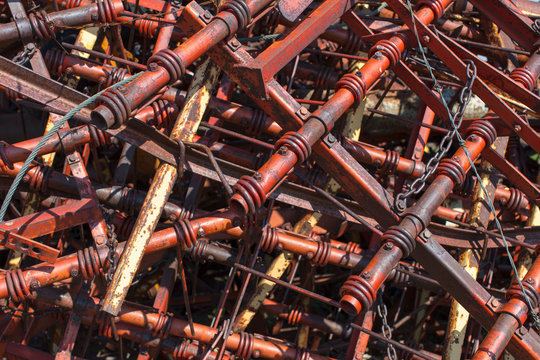 Close up of discarded farming equipment in rural landfill