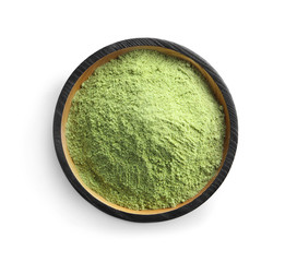 Plate with wheat grass powder on white background, top view
