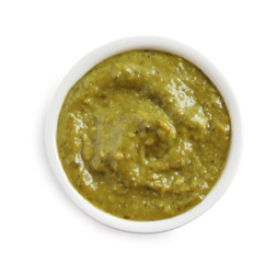Delicious pesto sauce in bowl on white background, top view