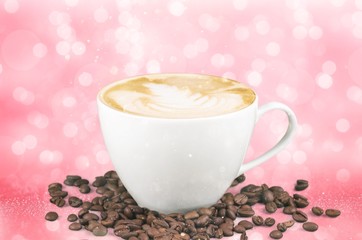 A cup of coffee with beans on pink background