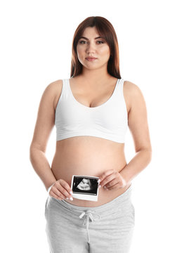 Pregnant woman with ultrasound picture on white background