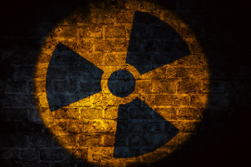 Nuclear energy radioactive (ionizing atomic radiation) round yellow symbol shape painted on brick...