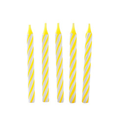 Yellow striped birthday candles isolated on white