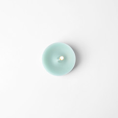 Light blue wax decorative candle isolated on white, top view