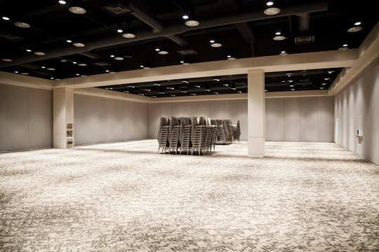 Chairs stacked in empty meeting room