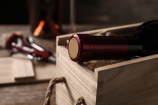 Open Wooden Crate With Bottle Of Wine On Blurred Background