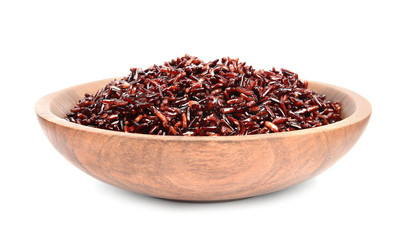 Bowl with delicious cooked brown rice on white background