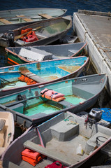 Fototapeta na wymiar Small fishing boats and dinghies lined up at the dock in Maine 
