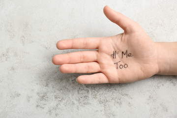Woman showing palm with hashtag METOO on grey background, closeup. Stop sexual assault