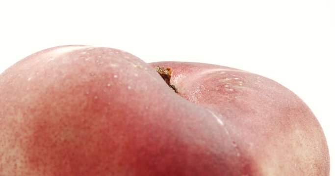 Donut peach isolated rotates on itself on white background. Snuffbox, Saturn, Tabacchiera rotation. Organic fruit.