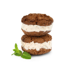 Sweet delicious ice cream cookie sandwiches and mint on white background