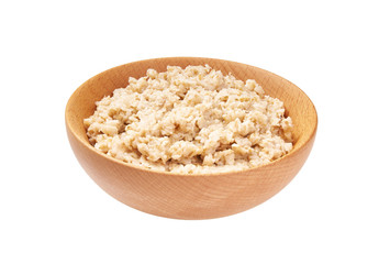 Wooden  bowl with prepared oatmeal  isolated on white background.
