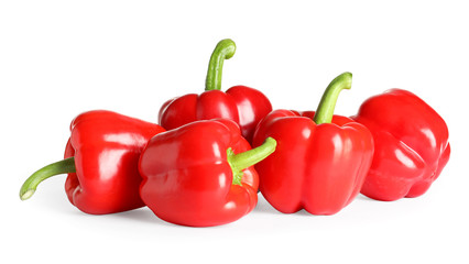 Tasty ripe red bell peppers on white background