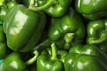 Ripe green bell peppers as background, top view