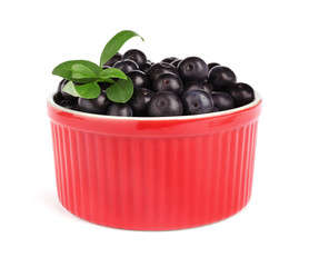 Bowl with fresh acai berries on white background