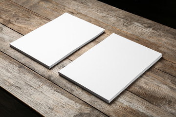 Blank paper sheets for brochure on wooden background. Mock up