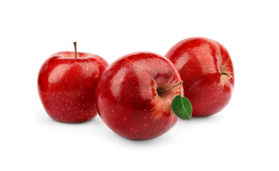 Ripe juicy red apples with leaf on white background