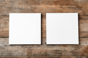 Blank paper sheets for brochure on wooden background, flat lay. Mock up