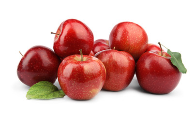 Ripe juicy red apples with leaves on white background