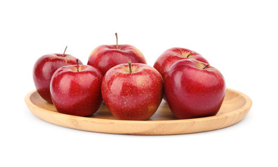 Wooden plate of ripe juicy red apples on white background