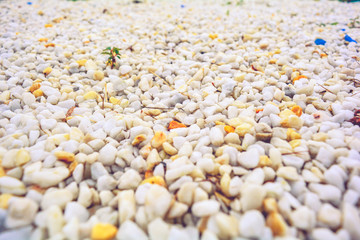 Pebbles white decorative gravel on the ground texture in perspective. Macro view