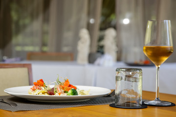 Ravioli and glass of wine served on the restaurant table