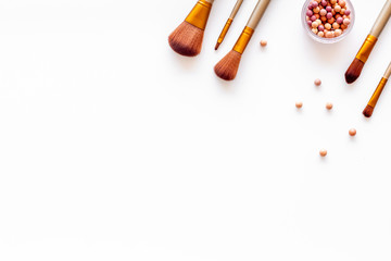 Brushes for make up, blusher on white visagiste work desk background top view copyspace