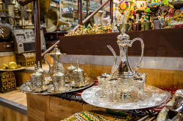 Two types of beautiful Omani Coffee (kahwa) cups and jug sets on display in a retail shop in Muscat, Oman.
