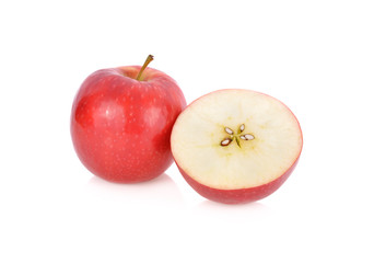 whole and half cut fresh pink lady apple with stem on white background