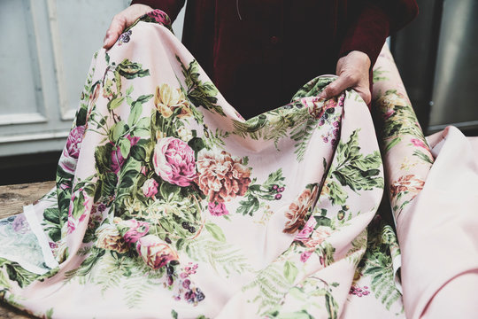 Midsection of woman holding pink floral fabric