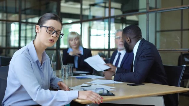 Stressed business woman suffering shouting emotional colleagues arguing office