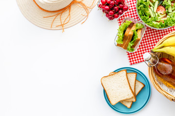 picnic in summer with products, fruits, drinks and hat on white background top view space for text