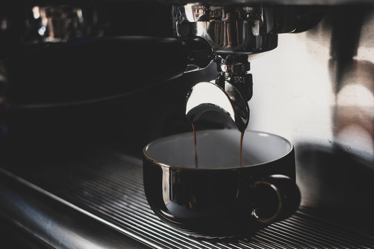 Close up of black mug on espresso machine