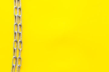 Chain for protection concept on yellow background top view mockup