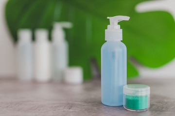 organic lotion isolated from a group of other skincare products with tropical leaf in the background