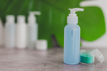 organic lotion isolated from a group of other skincare products with tropical leaf in the background