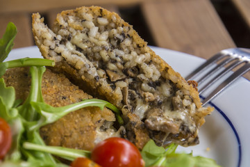 Arancini; Stuffed rice balls which are coated with bread crumbs and then deep fried