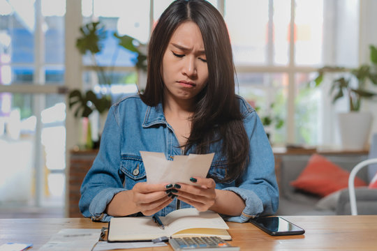 Person calculating expense in house.