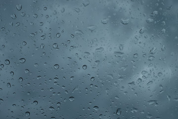 Raindrops on the window close up. rain drops on the glass macro. water drops falling down on window. rainy day