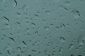 Raindrops on the window close up. rain drops on the glass macro. water drops falling down on window. rainy day